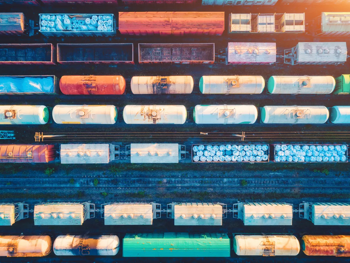 An aerial view of freight wagons lined up in a rail yard.