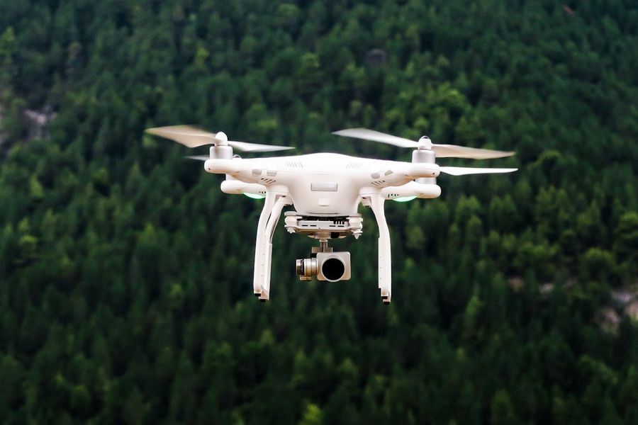 A survey drone flying over a forest.